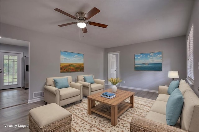 living room featuring ceiling fan and light wood-type flooring