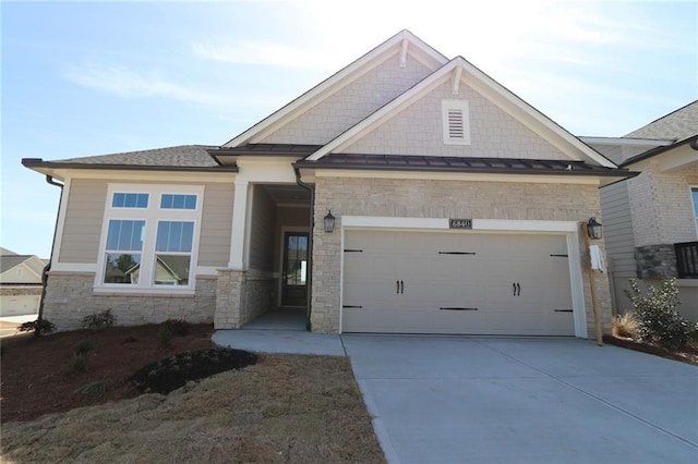 craftsman-style house featuring driveway, an attached garage, and a standing seam roof