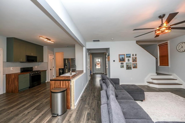 kitchen with visible vents, stainless steel range with gas stovetop, fridge with ice dispenser, a sink, and black microwave