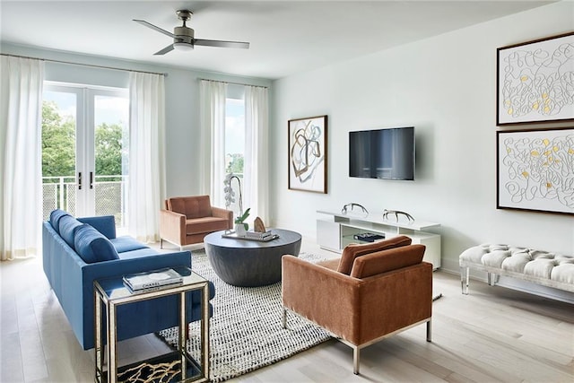 living room with wood-type flooring, french doors, and ceiling fan