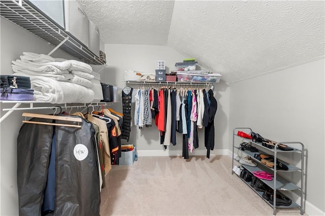spacious closet featuring carpet floors and vaulted ceiling