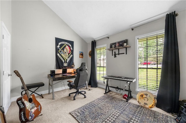 carpeted office space featuring high vaulted ceiling and baseboards