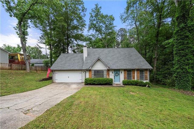 view of front facade with a chimney, fence, a front lawn, concrete driveway, and an attached garage