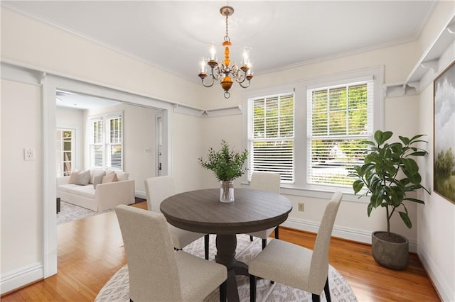 4 Arc Way NE, Atlanta, GA 30305 - dining space featuring healthy amount of natural light, a chandelier, baseboards, and crown molding