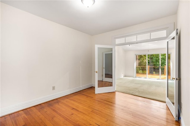 4 Arc Way NE, Atlanta, GA 30305 - spare room featuring light wood finished floors, baseboards, and french doors