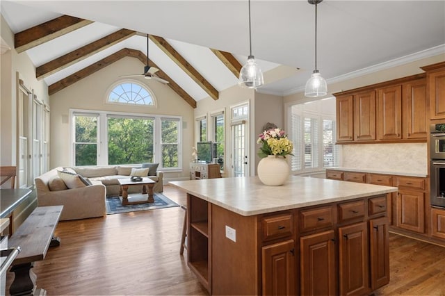 kitchen with light countertops, brown cabinets, dark wood-type flooring, open floor plan, and beamed ceiling