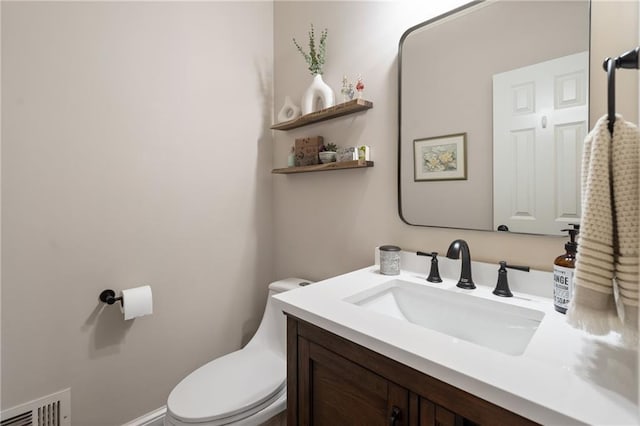 bathroom with toilet and vanity