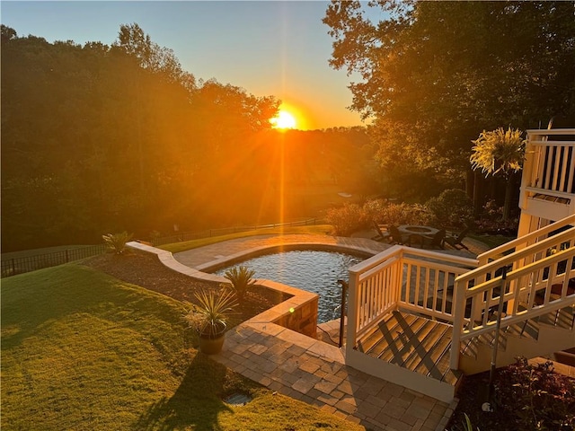 view of pool at dusk