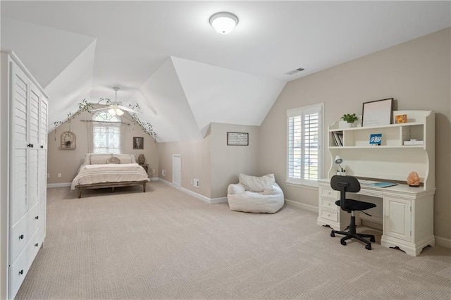 bedroom featuring light carpet, vaulted ceiling, baseboards, and an office area