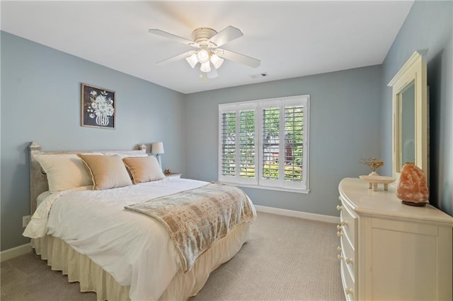 bedroom with baseboards, light carpet, and ceiling fan
