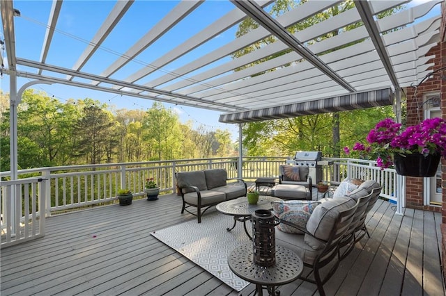 wooden deck featuring outdoor lounge area, grilling area, and a pergola