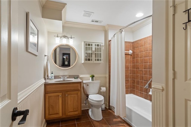 full bathroom with tile patterned floors, ornamental molding, wainscoting, shower / tub combo with curtain, and toilet