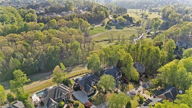 view of property location with a heavily wooded area and nearby suburban area