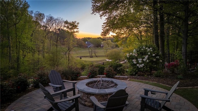 view of patio featuring a fire pit and fence
