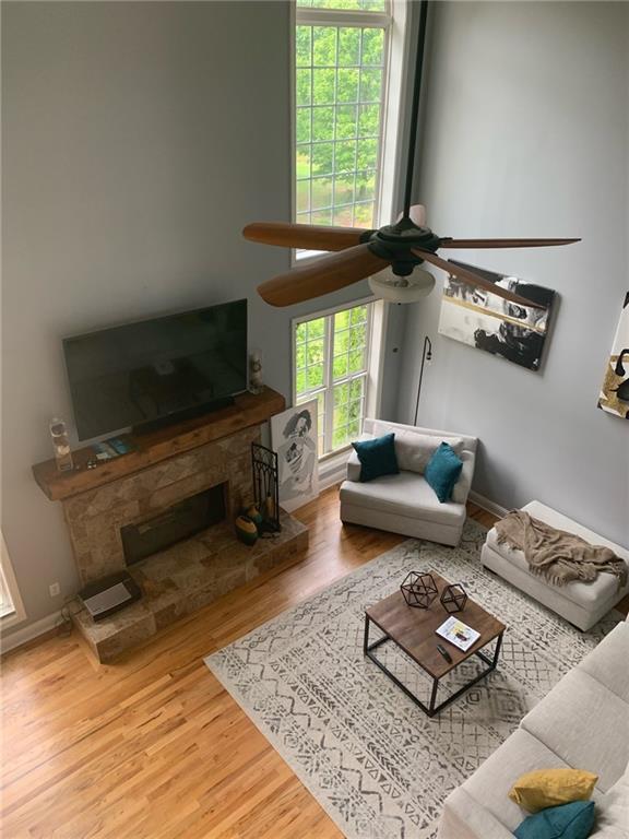 living room with hardwood / wood-style flooring and a towering ceiling