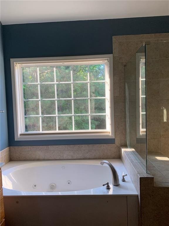 bathroom featuring separate shower and tub