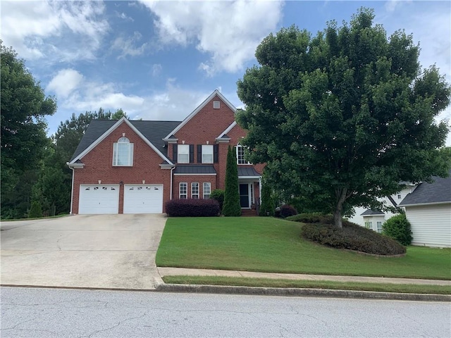 view of front of property with a garage and a front yard