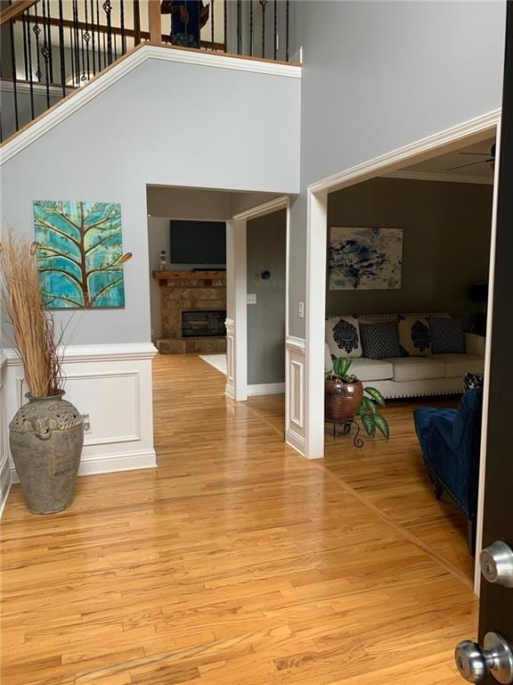 stairway featuring a towering ceiling and hardwood / wood-style floors