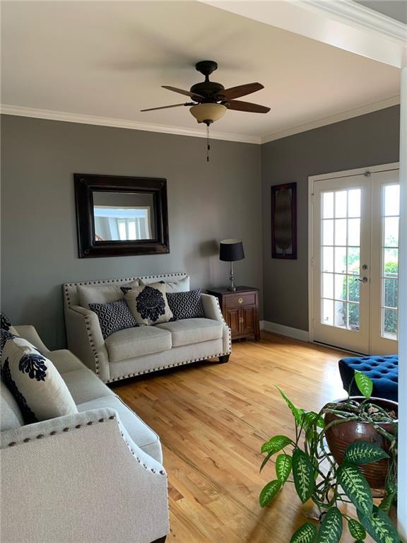 entrance foyer featuring light hardwood / wood-style flooring, ceiling fan, and a high ceiling