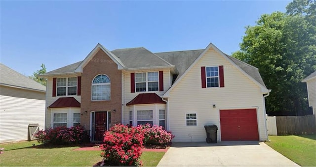 view of front of property with a front lawn and a garage