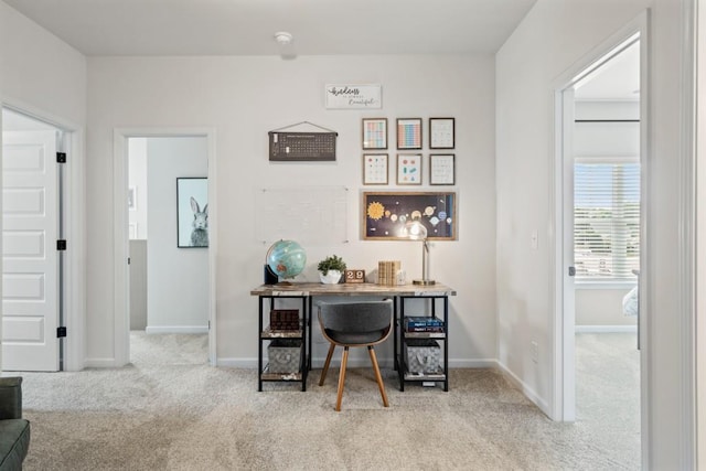 carpeted office featuring baseboards