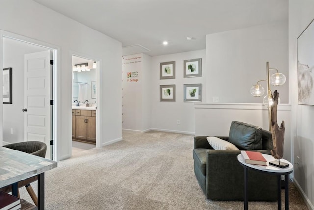 living area featuring recessed lighting, baseboards, and light carpet