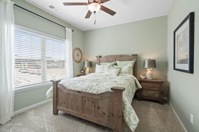 carpeted bedroom with visible vents, ceiling fan, and baseboards