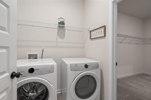 laundry area featuring carpet, laundry area, separate washer and dryer, and baseboards