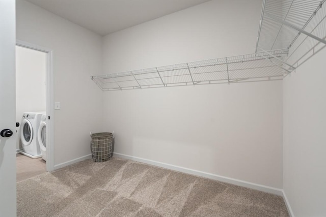 spacious closet with carpet floors and separate washer and dryer