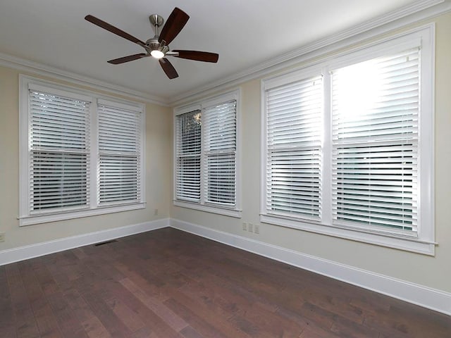 spare room with ceiling fan, dark hardwood / wood-style flooring, and crown molding