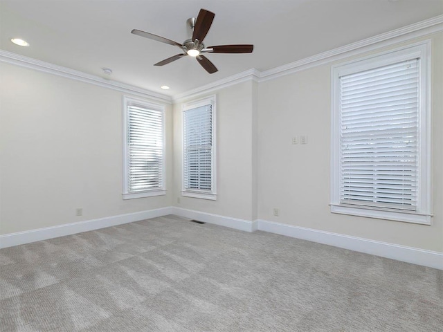 empty room with light carpet, ceiling fan, and ornamental molding