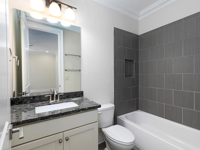 full bathroom with crown molding, vanity, tiled shower / bath combo, and toilet