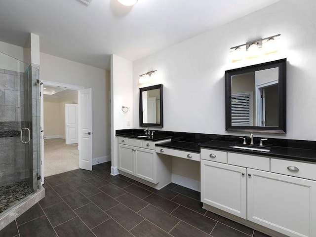 bathroom with vanity and a shower with door