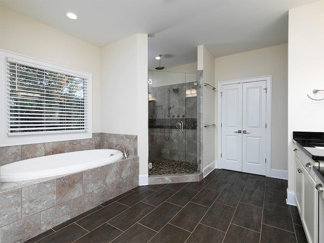 bathroom featuring tile patterned flooring, vanity, and separate shower and tub