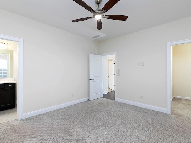 unfurnished bedroom with light carpet, ensuite bath, and ceiling fan