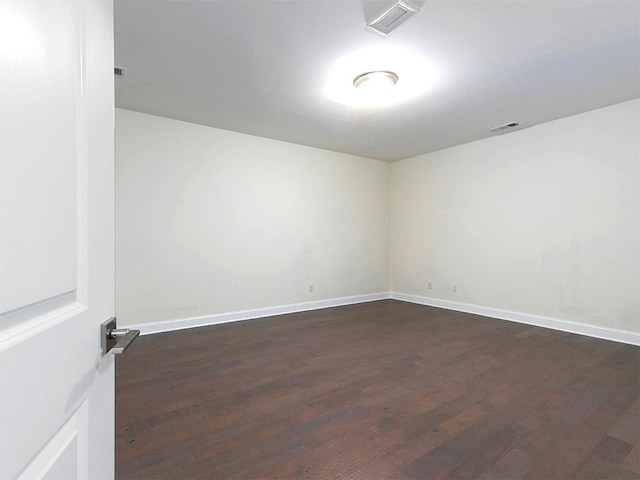 unfurnished room featuring dark wood-type flooring