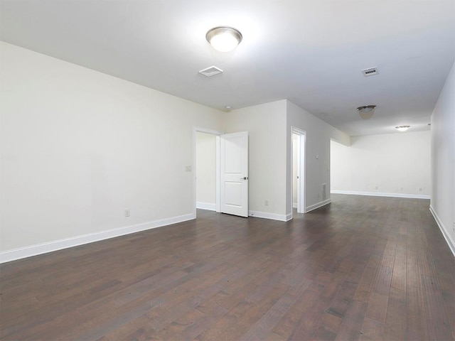 unfurnished room featuring dark wood-type flooring