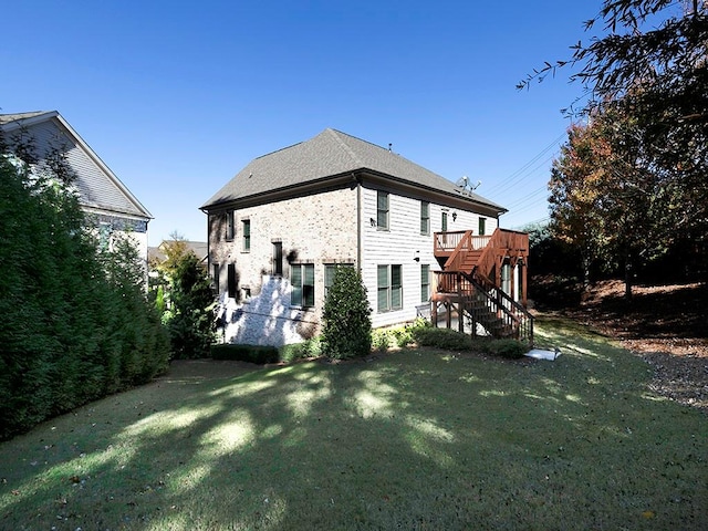 back of house with a yard and a wooden deck