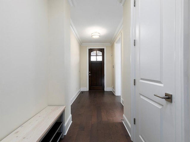 doorway to outside with dark hardwood / wood-style flooring and crown molding