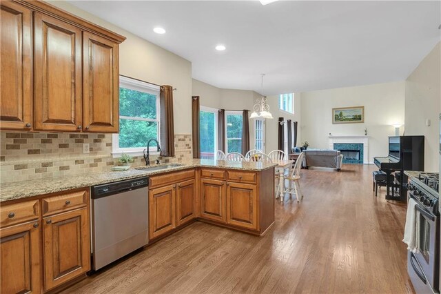 2810 Olde Town Park Dr, Norcross, GA 30071 - kitchen featuring brown cabinets, a peninsula, appliances with stainless steel finishes, and a sink