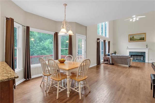 2810 Olde Town Park Dr, Norcross, GA 30071 - dining space featuring a fireplace, wood finished floors, a ceiling fan, and baseboards