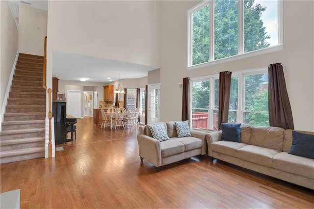 2810 Olde Town Park Dr, Norcross, GA 30071 - living room featuring stairway, wood finished floors, and a high ceiling