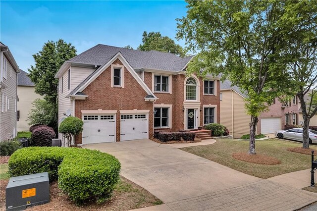 2810 Olde Town Park Dr, Norcross, GA 30071 - view of front of home with brick siding, cooling unit, a garage, a front lawn, and concrete driveway