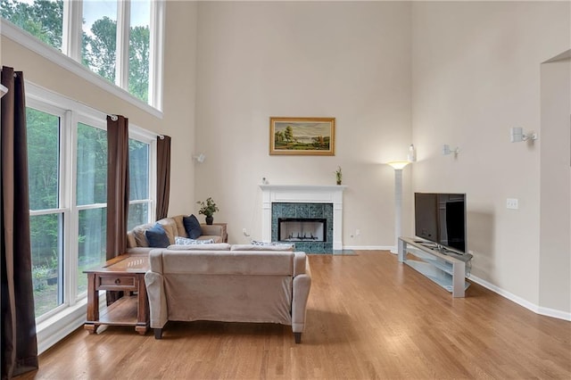 2810 Olde Town Park Dr, Norcross, GA 30071 - living area with a towering ceiling, light wood-style floors, a healthy amount of sunlight, and baseboards