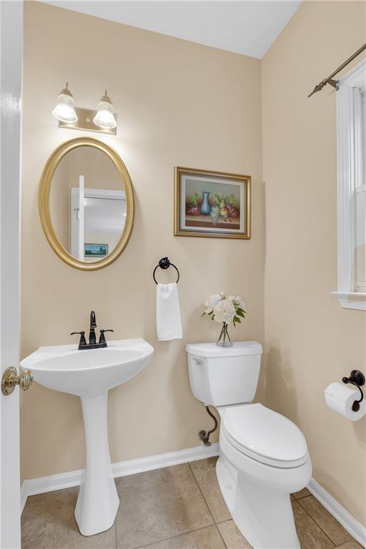 2810 Olde Town Park Dr, Norcross, GA 30071 - bathroom featuring tile patterned floors, baseboards, toilet, and a sink