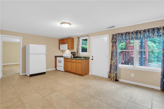 2810 Olde Town Park Dr, Norcross, GA 30071 - kitchen featuring brown cabinets, white appliances, visible vents, baseboards, and dark countertops