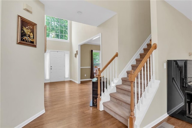 2810 Olde Town Park Dr, Norcross, GA 30071 - foyer with baseboards, stairway, wood finished floors, and a towering ceiling