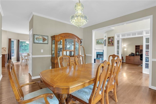 2810 Olde Town Park Dr, Norcross, GA 30071 - dining area featuring ornamental molding, a notable chandelier, baseboards, and light wood-style floors