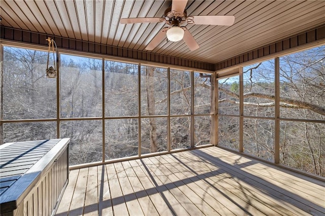 unfurnished sunroom featuring a ceiling fan and wood ceiling