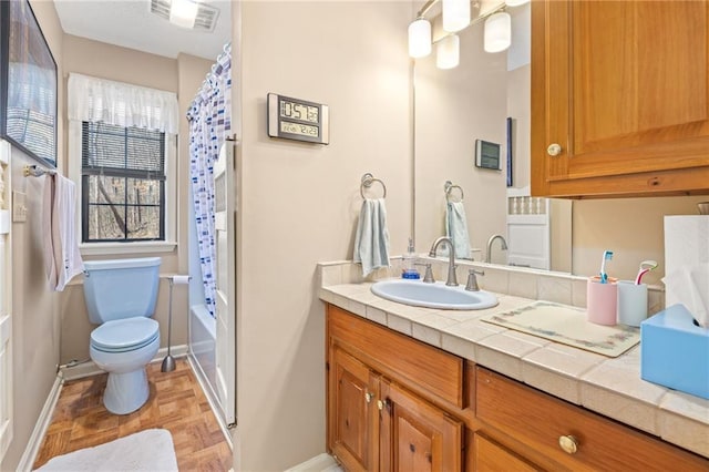 bathroom featuring toilet, visible vents, vanity, baseboards, and shower / bath combo with shower curtain